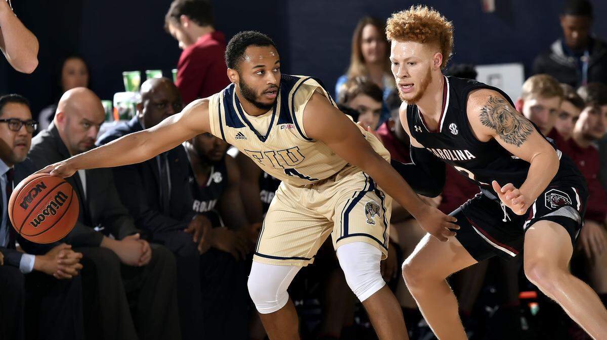 2017 November 27 - 
FIU’s Brian Beard (4) battles for position against South Carolina’s Hassani Gravett (2) on Nov. 27.