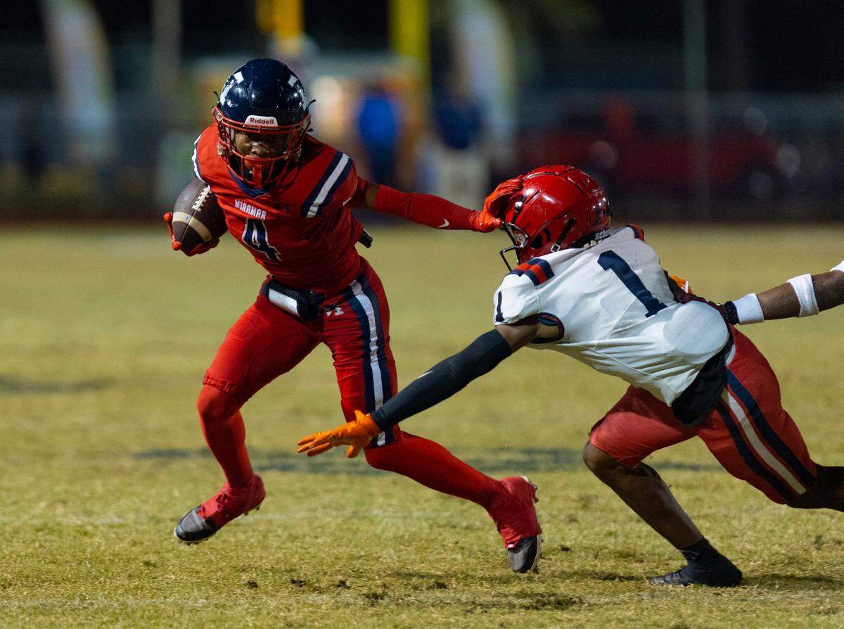 Miramar’s Cenard Bennett (4) runs the ball around American’s Keyon Bryant (1) during the first quarter of a playoff game between American and Miramar on Thursday, Nov. 9, 2023, at Miramar High School.