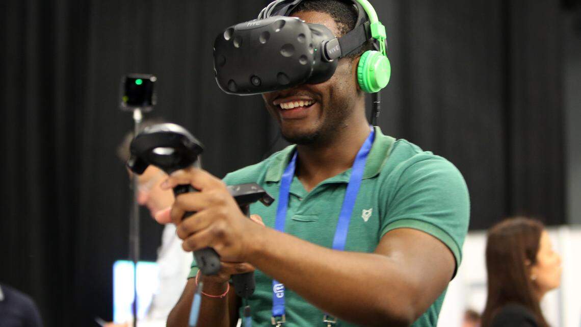 Steve Pierre, a communications manager at the University of Miami, plays a virtual reality game created by startup company Indie Level Studio at the eMerge Americas conference at the Miami Beach Convention Center in April 2018. The game is a tool for teachers to teach students foreign languages, biology, and astronomy.