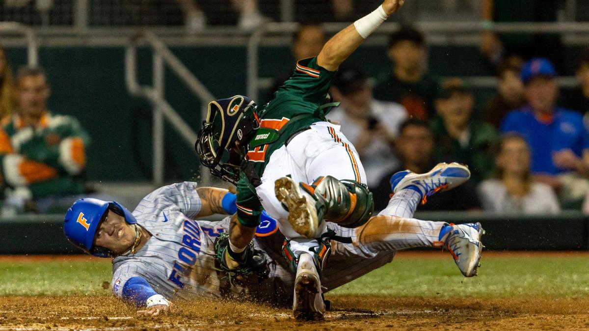 Florida base runner Ty Evans (2) slides into home past Hurricanes catcher Carlos Perez (61) to score a run during the fourth inning of an NCAA baseball game inside Alex Rodriguez Park at Mark Light Field in Coral Gables, Florida on Friday, March 1, 2024