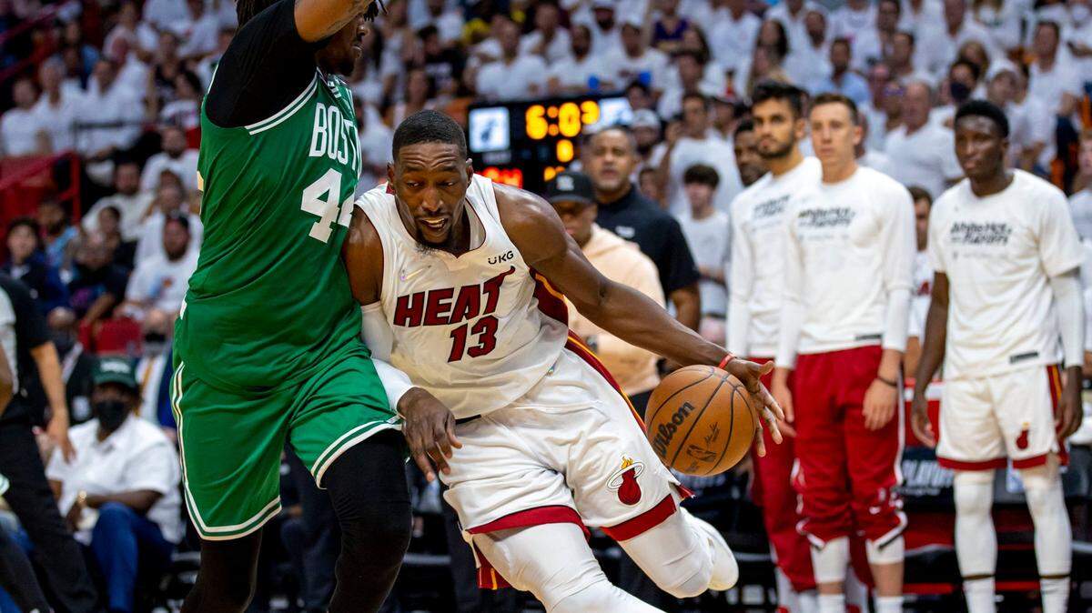 Miami Heat center Bam Adebayo (13) drives into the paint against Boston Celtics center Robert Williams III (44) as teammates look on from the sideline during the second half of Game 1 of the NBA Eastern Conference Finals series at FTX Arena in Miami, Florida, on Tuesday, May 17, 2022.