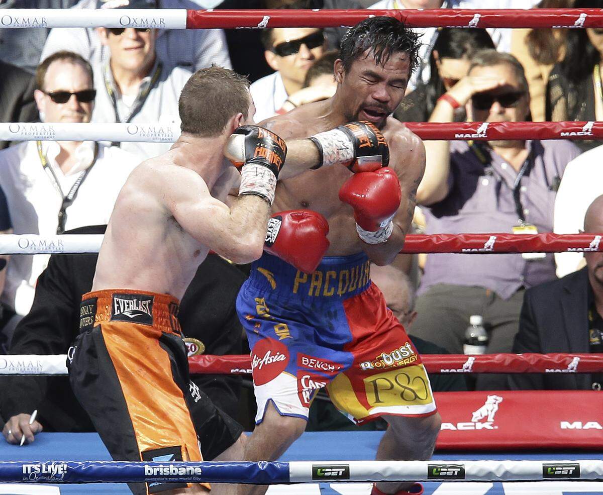 Manny Pacquiao, right, of the Philippines and Jeff Horn of Australia fight during their WBO World welterweight title bout in Brisbane, Australia, Sunday, July 2, 2017. Pacquiao lost his WBO welterweight world title to Horn in a stunning, unanimous points decision in the Sunday afternoon bout billed as the Battle of Brisbane in front of more than 50,000 people.