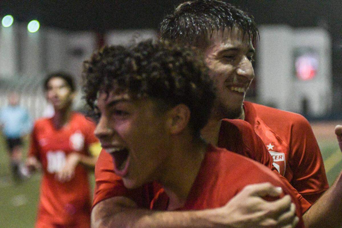 Doral Academy’s Angel Perez (front) celebrates with Kaleb Jiron after scoring a first-half goal in the Firebirds’ regional final win over Dwyer on Wednesday, Feb. 16, 2022, at Doral Academy.