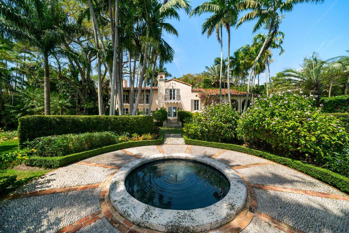 Villa Serenita, in the Moorings gated community, includes lush grounds, a koi pond and fountain.