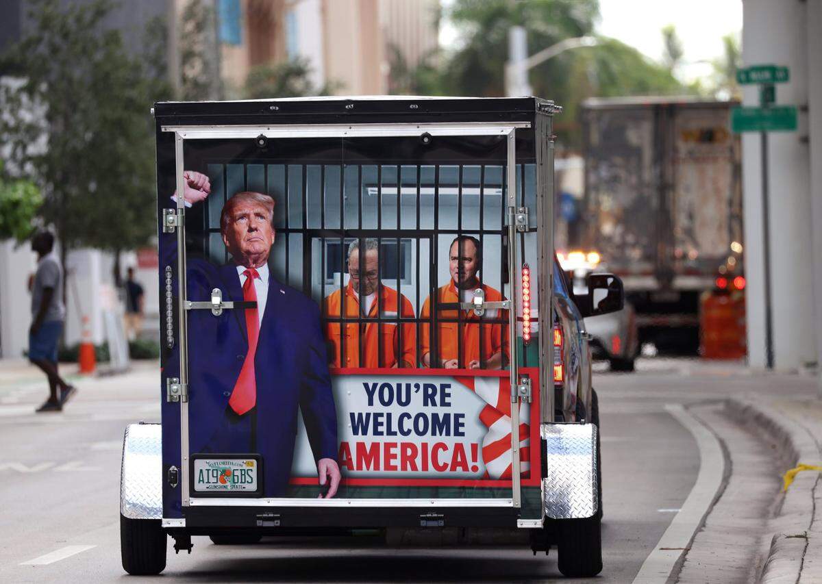 Demonstrators rally outside at the Wilkie D. Ferguson Jr. U.S. Courthouse, Tuesday, June 13, 2023, in Miami, prior to former President Donald Trump’s arraignment.