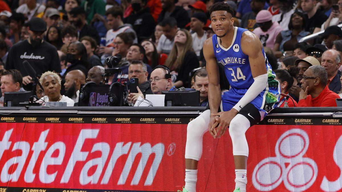 Milwaukee Bucks forward Giannis Antetokounmpo (34) sits on the scorers table against the Washington Wizards in the fourth quarter at Capital One Arena.