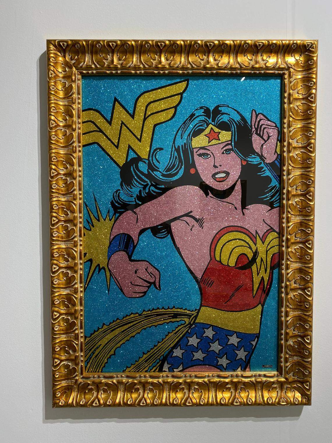 Glittery versions of Superwoman and Batman are offered for $11,000 at Larenland Art Space at the Scope fair in 2019. 