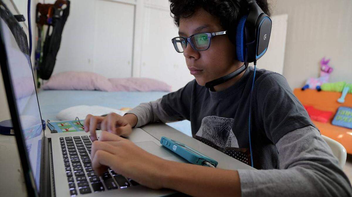 Javier Alonso, a student at Linda Lentin K-8 Center School in North Miami, connects with school online in April 2020.