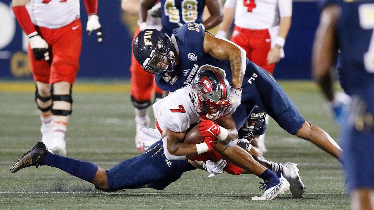 FIU Panthers linebacker Daniel Jackson (10) tackles Western Kentucky Hilltoppers running back Adam Cofield (7) during football game Saturday, October 23, 2021 at Riccardo Silva Stadium in Miami