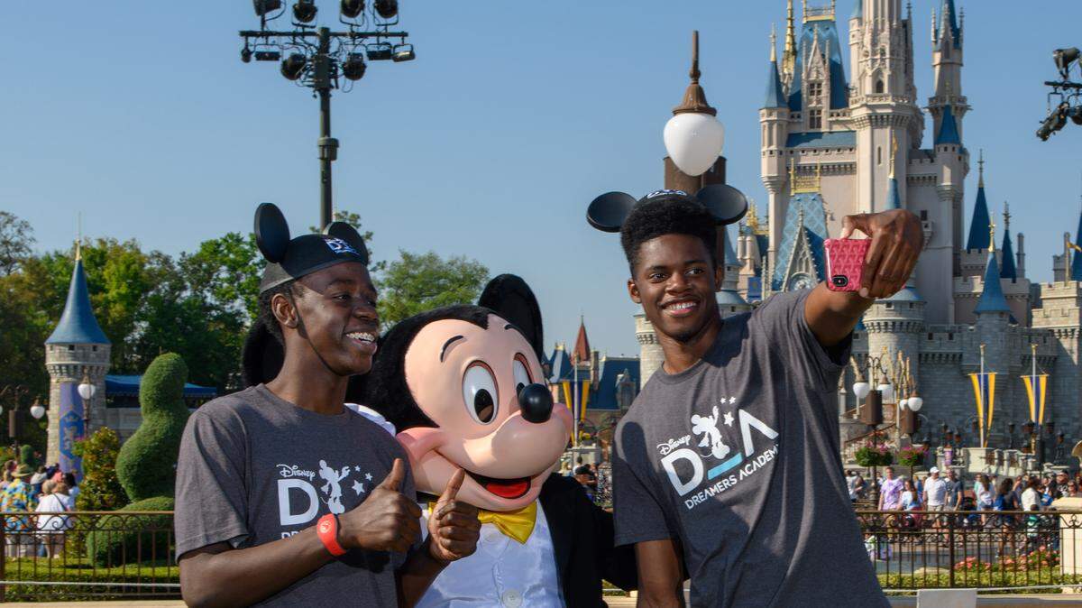 Mickey Mouse welcomes two high school students from Miami, Fla., on Thursday, March 21, to Magic Kingdom in Lake Buena Vista, Fla. during the 12th annual Disney Dreamers Academy. The event, taking place March 21-24, 2019. at Walt Disney World Resort, is a career-inspiration program for distinguished high school students from across the U.S.