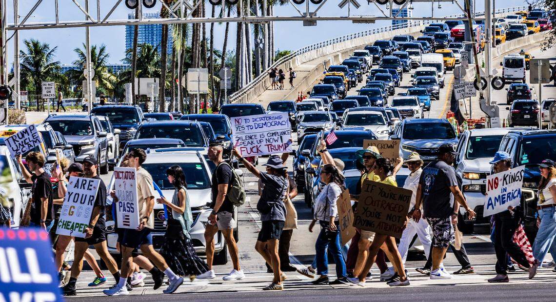 Protesters crossing traffic out of PortMiami on Biscayne Boulevard as they marched from the Torch of Friendship to the Freedom Tower, in downtown Miami during the ‘No Kings’ anti-Trump protests.