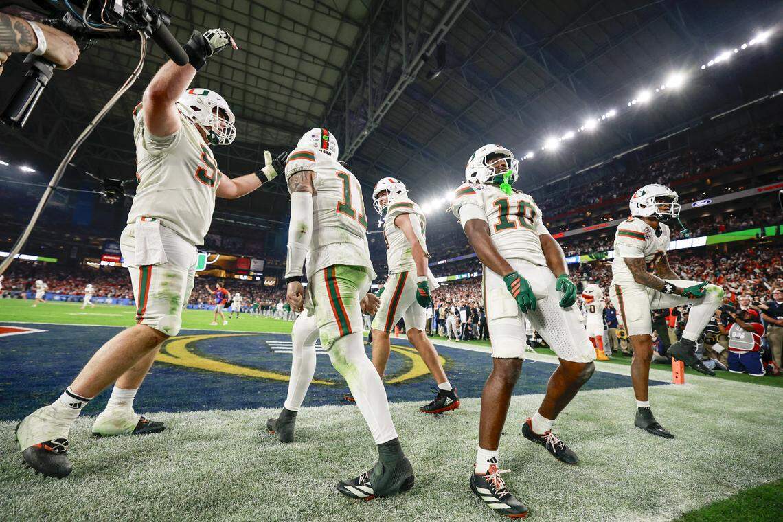 Miami Hurricanes quarterback Carson Beck (11) and teammates celebrate after scoring during the second half of a College Football Playoff semifinal against the Mississippi Rebels in the Fiesta Bowl at State Farm Stadium on Thursday, January 8, 2026 in Glendale, Arizona.