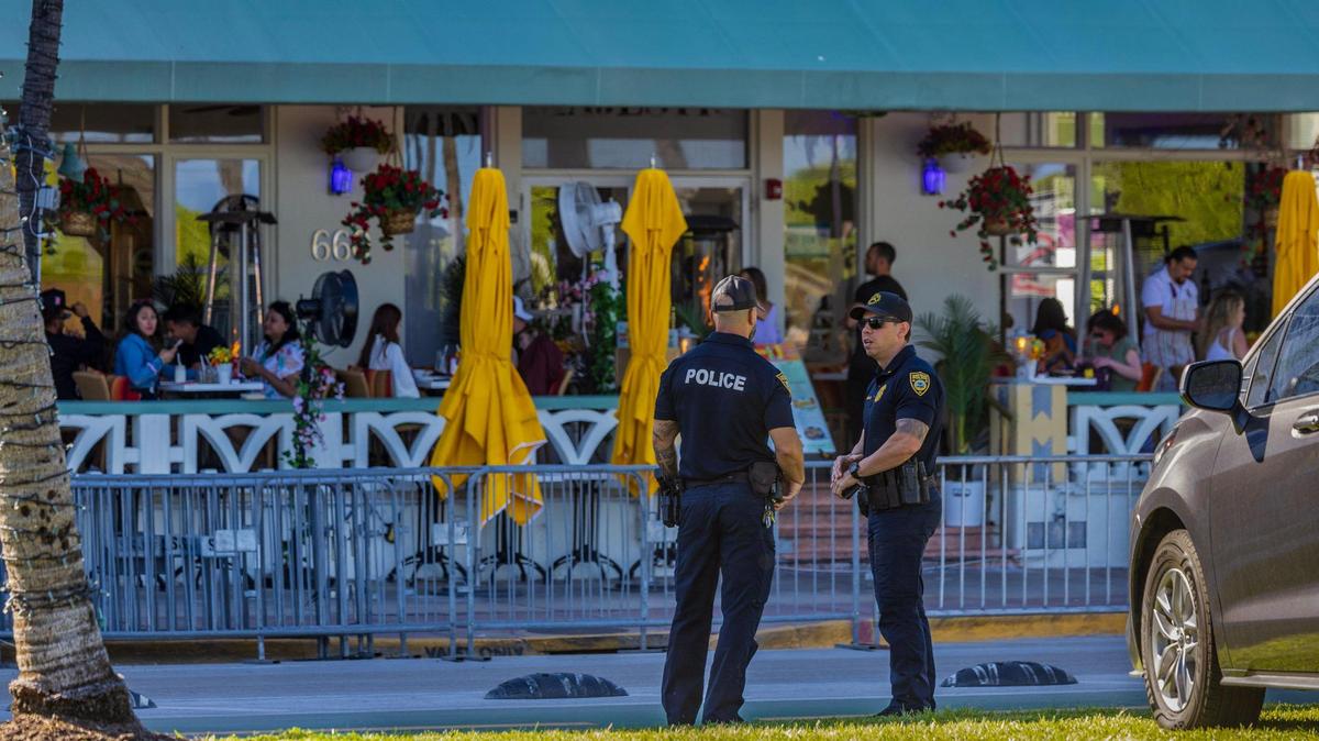 Miami Beach police officers stand on Ocean Drive during spring break on Friday, March 21, 2025.