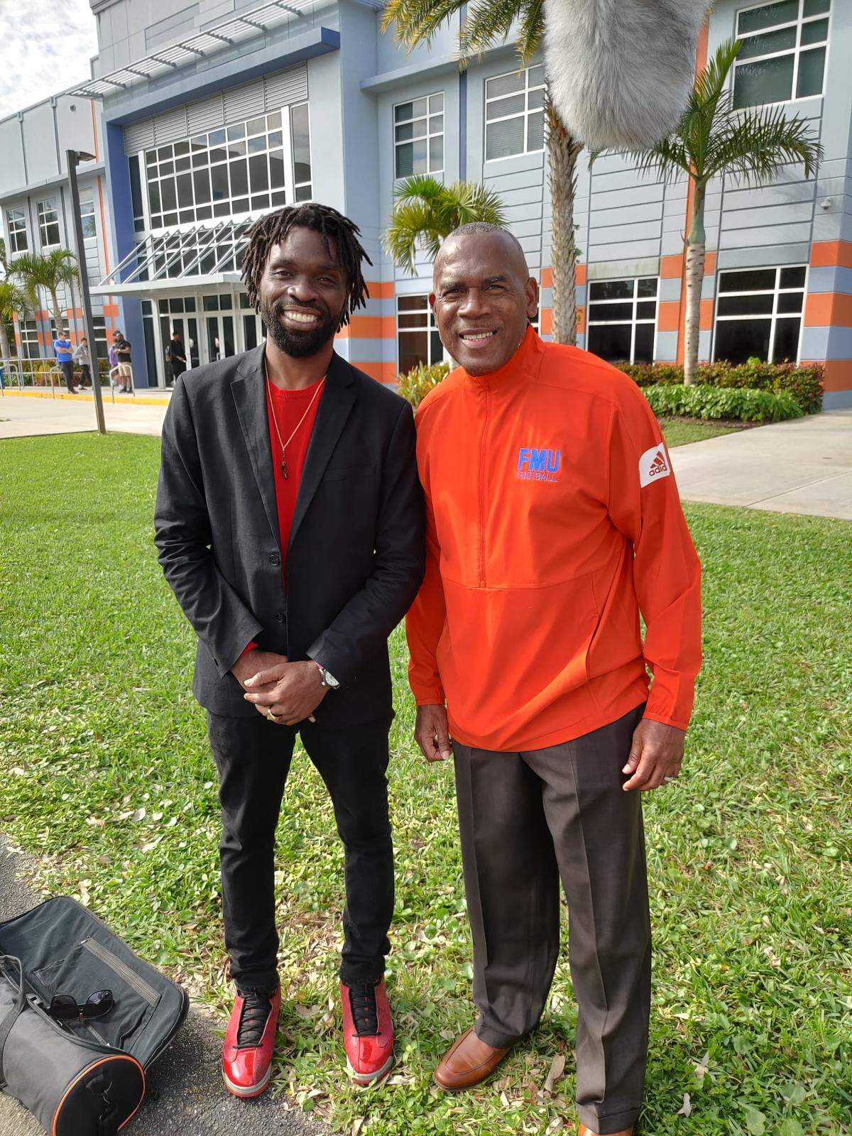 Filmmaker Nicanson Guerrier (left) poses with former Booker T. Washington head coach and current Miami Hurricanes running backs coach Tim “Ice” Harris after an interview for “The Mecca: Legends of Traz Powell.” “The Mecca” explores the significance of Miami high school football and Traz Powell Stadium.