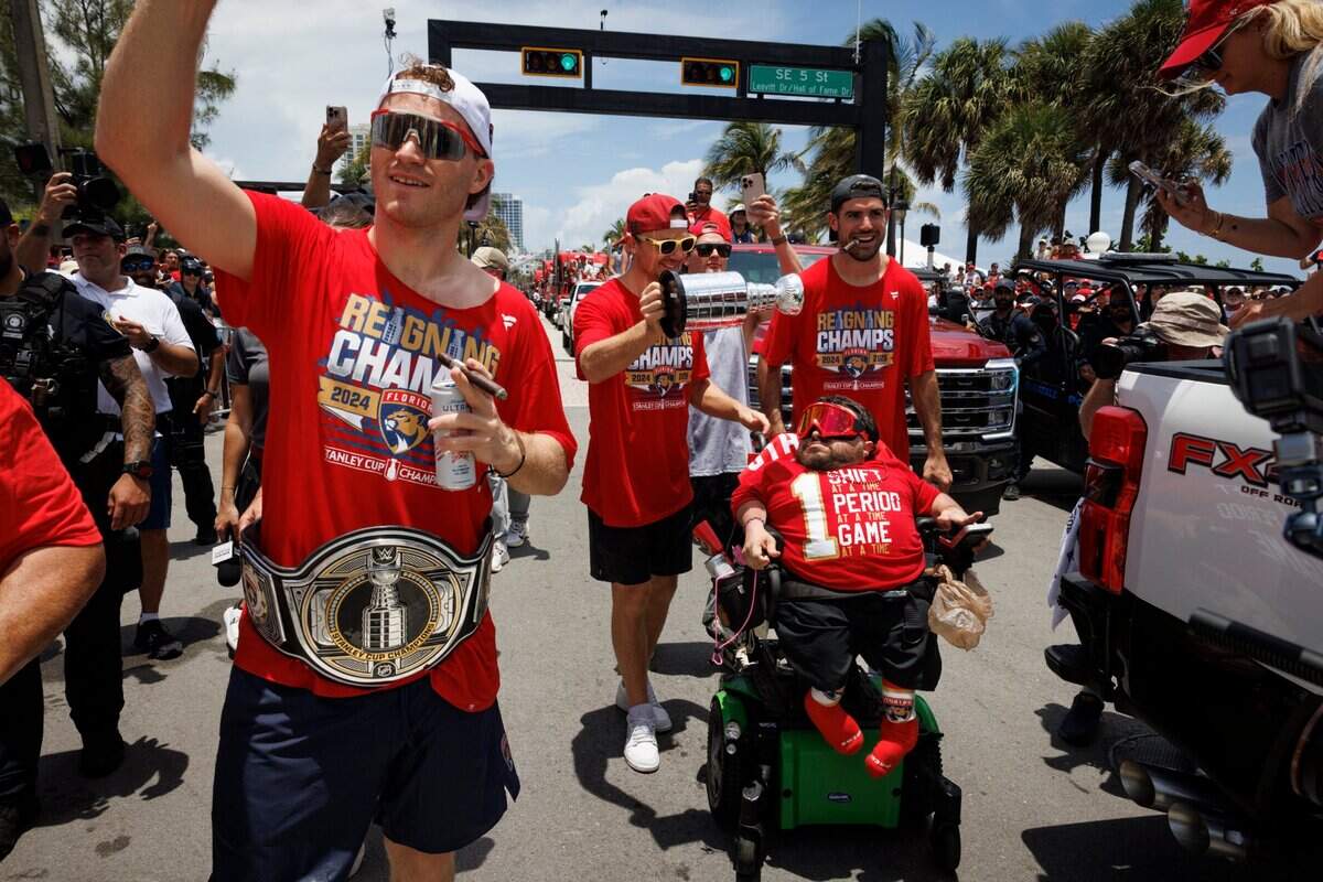 Florida Panthers Matthew Tkachuk (19) and Sam Reinhart (13) pull dedicated podcaster and Florida Panthers superfan Cesar Lucero out of the crowd to walk in the parade with them during the Florida Panthers Stanley Cup Championship victory parade on Sunday, June 22, 2025 down Las Olas in Fort Lauderdale, Fla.