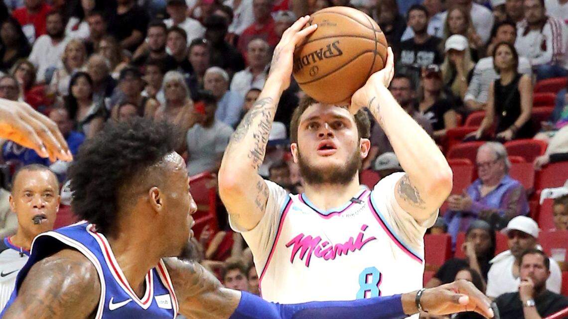 Miami Heat guard Tyler Johnson looks to shoot over Philadelphia 76ers forward Robert Covington in a February game. Johnson's salary is set to rise dramatically this season.