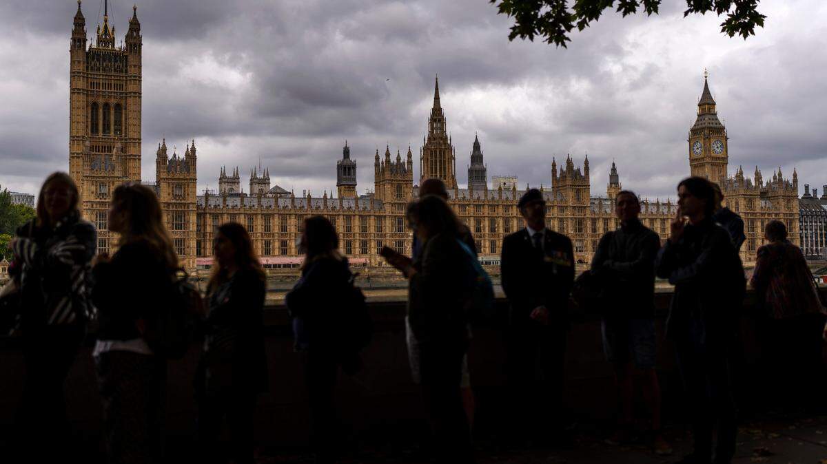 People are waiting for hours in The Queue, a miles-long line, to pay their respects at Queen Elizabeth II’s coffin at the lying-in-state in London, England.