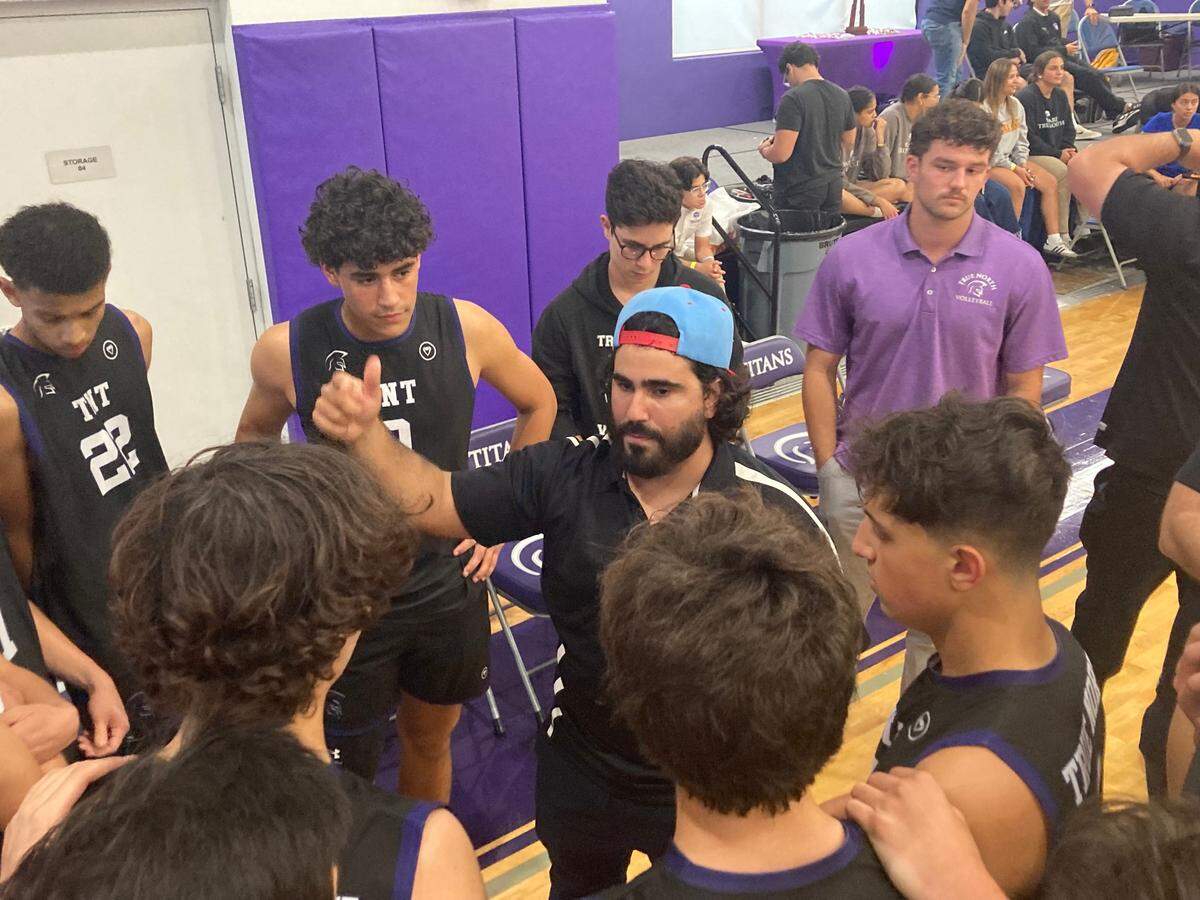 True North coach Jonathan Losada (middle) speaks to his players during a timeout in Tuesday’s Region 4-1A final win over La Salle.