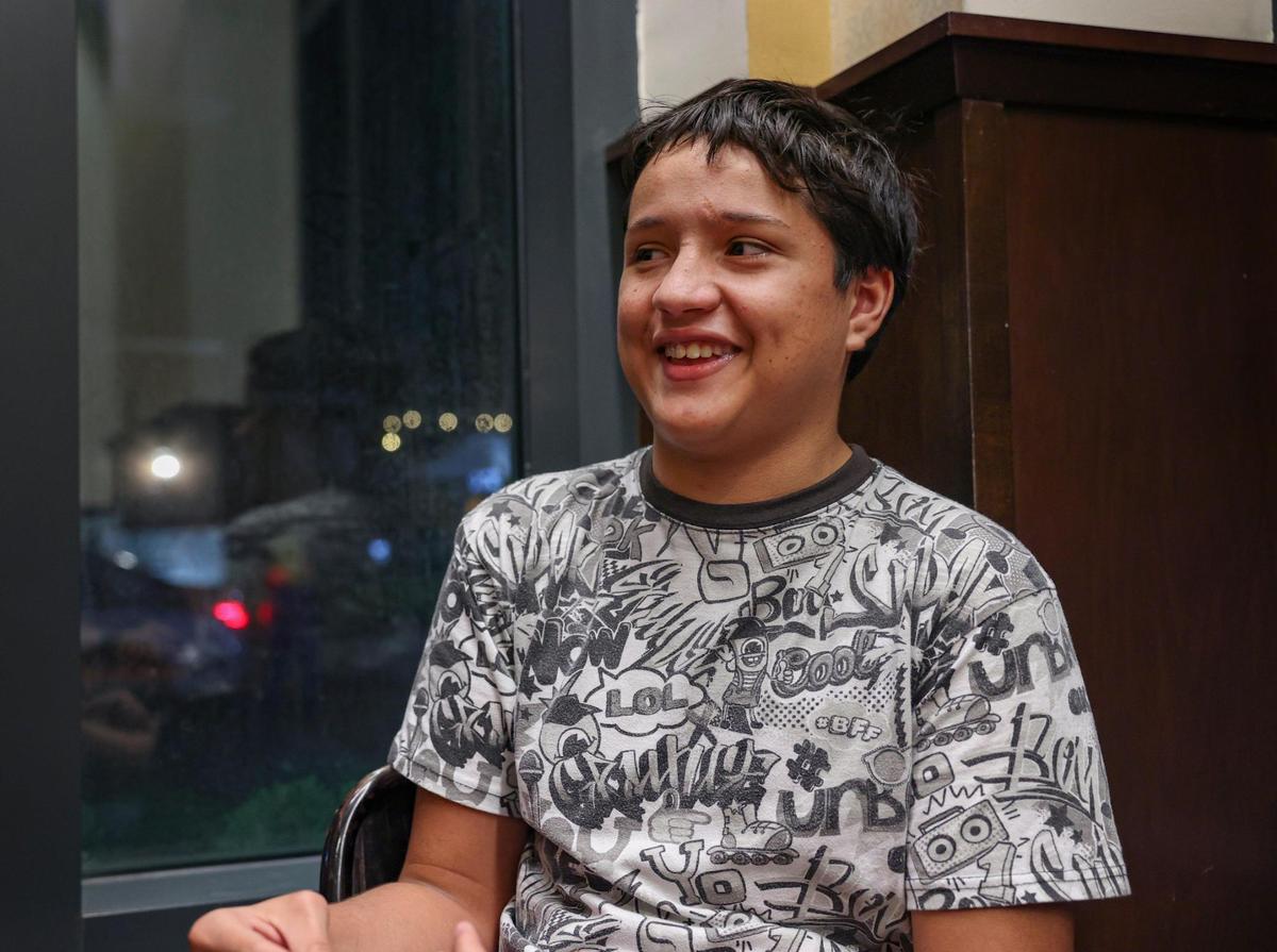 Adrian Gutierrez-Elbers sits in a bookstore in Pembroke Pines on Tuesday, Dec. 6, 2022. He has a learning disability that affects his reading comprehension, so he is asking for a private tutor to help increase his reading level. He also enjoys researching marine biology and would love to get SCUBA certified so he can advance his interest in marine life.