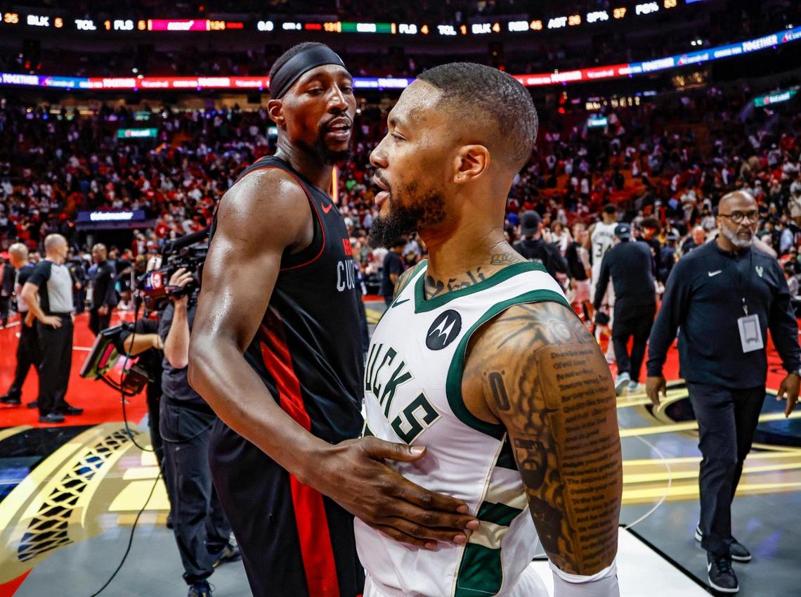 Miami Heat center Bam Adebayo (13) meets up with Milwaukee Bucks guard Damian Lillard (0) after losing against the Bucks at the Kaseya Center in Miami on Tuesday, November 28, 2023.
