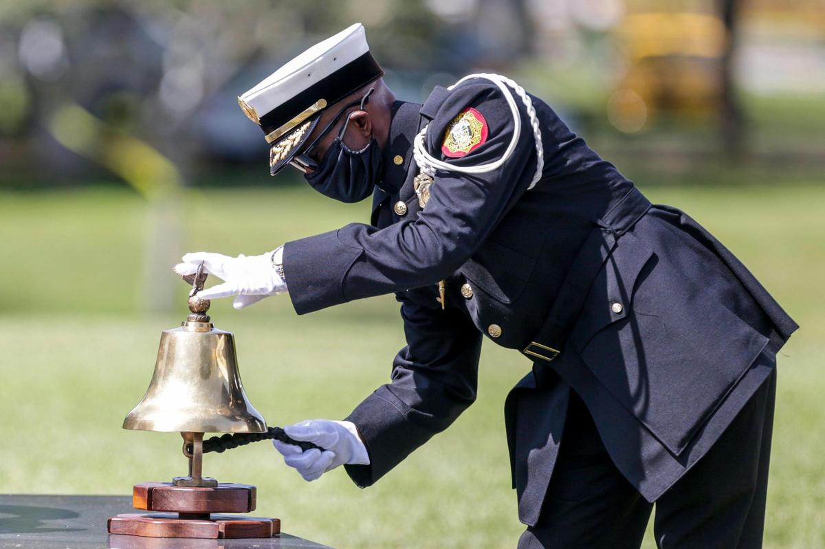 Lieutenant Walter Wray of Miami-Dade Fire Rescue, rings a bell to conclude a 9/11 Ceremony of Remembrance at Tropical Park in Miami, Florida on Saturday, September 11, 2021.