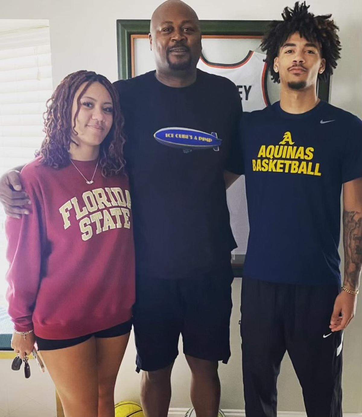 St. Thomas Aquinas basketball standout Dwayne Wimbley Jr. (right) with his father, Dwayne Sr. (middle) and sister Alexia (left).