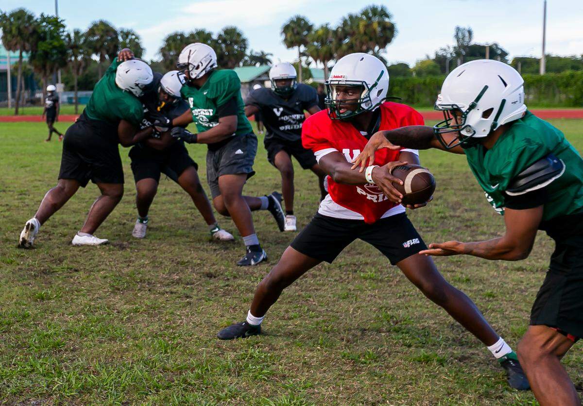 Miami Central quarterback Keyone Jenkins, center, runs drills with his teammates during a preseason practice at his school’s football field in Miami’s West Little River neighborhood on Thursday, August 5, 2021.