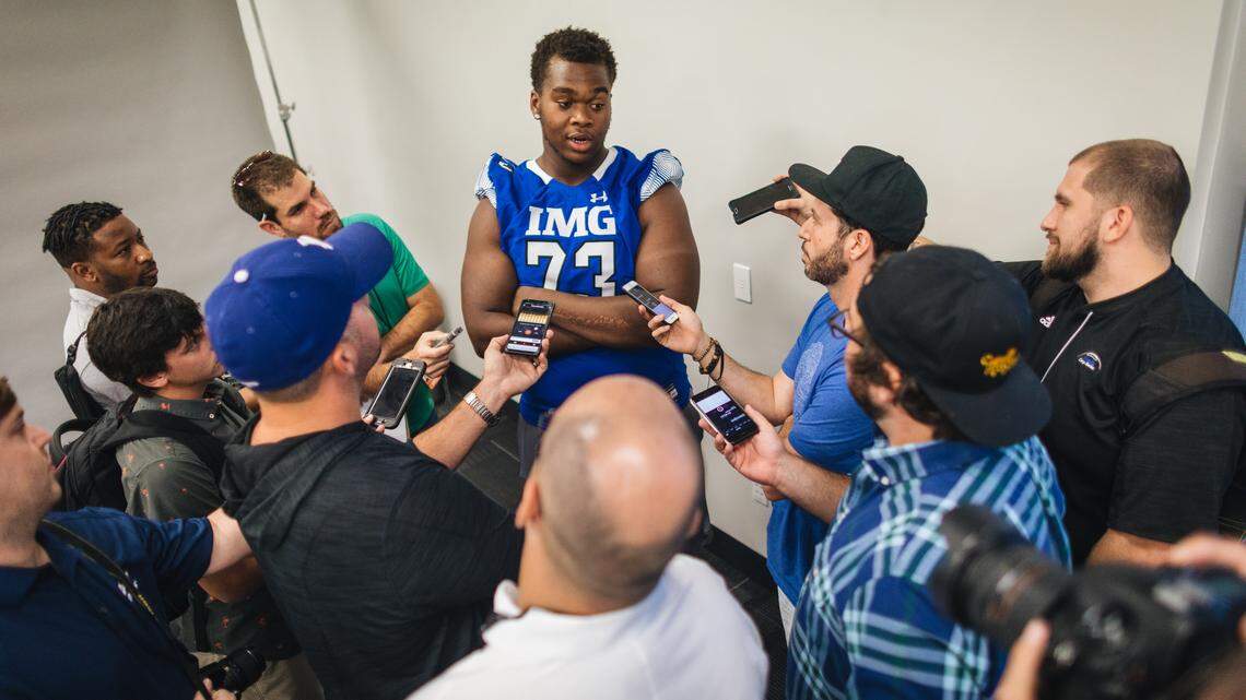 Evan Neal talks to reporters.