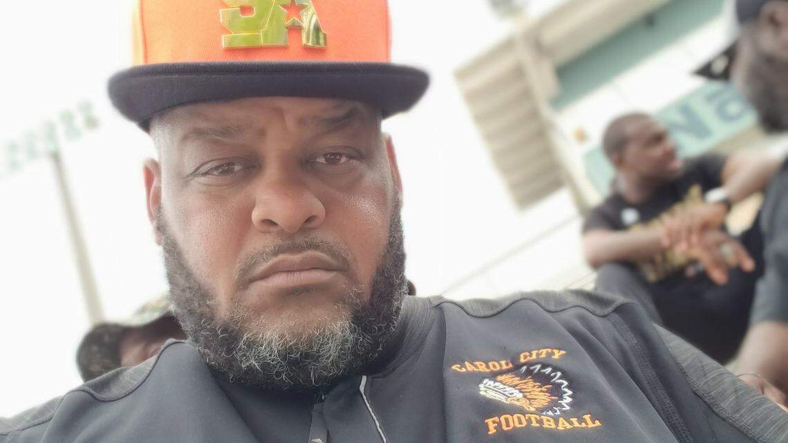 Longtime Carol City assistant coach Andre C. Stafford poses for a photo prior to the team's spring game at Traz Powell Stadium.