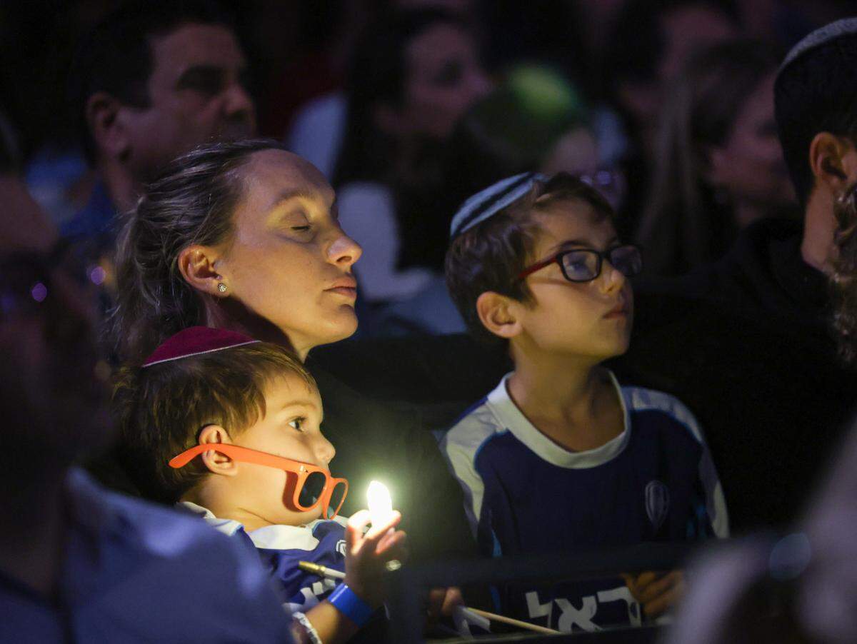 A family listens during last year’s commemorative ceremony marking one year of the October 7 attack by Hamas in Israel at the David Posnack Jewish Community Center in Davie.