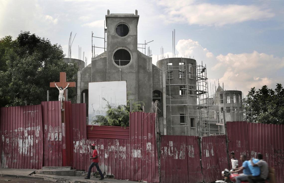 Eglise Sacré-Coeur in Turgeau collapsed in the January 2010 earthquake, with only the statue of Jesus on the cross in front surviving. Rebuilding has been slow.