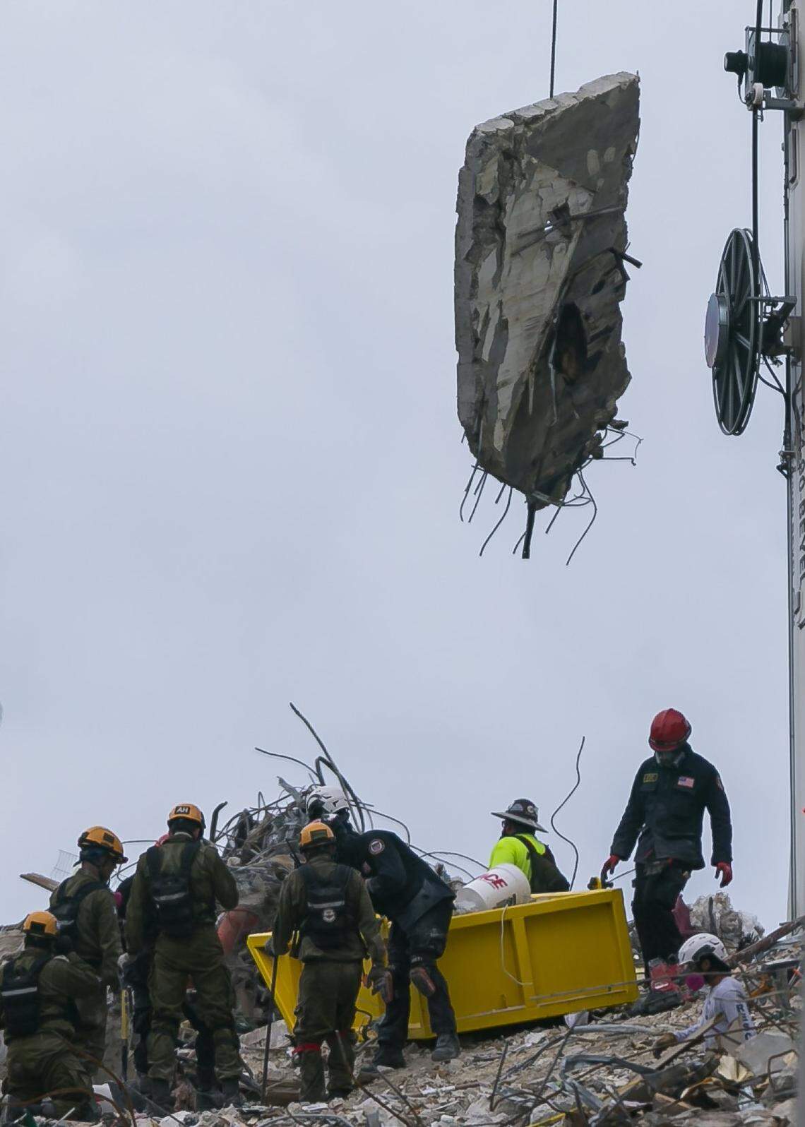A piece of debris is lifted as rescue crews continue to look through rubble for survivors at the partially collapsed Champlain Towers South condo building in Surfside, Florida on Tuesday, June 29, 2021.