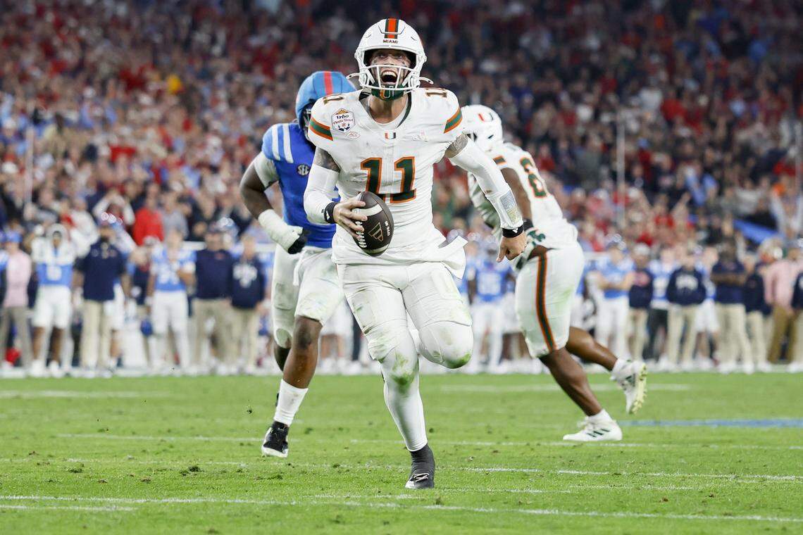 Miami Hurricanes quarterback Carson Beck (11) runs in to score during the second half of a College Football Playoff semifinal against the Mississippi Rebels in the Fiesta Bowl at State Farm Stadium on Friday, January 9, 2026 in Glendale, Arizona.