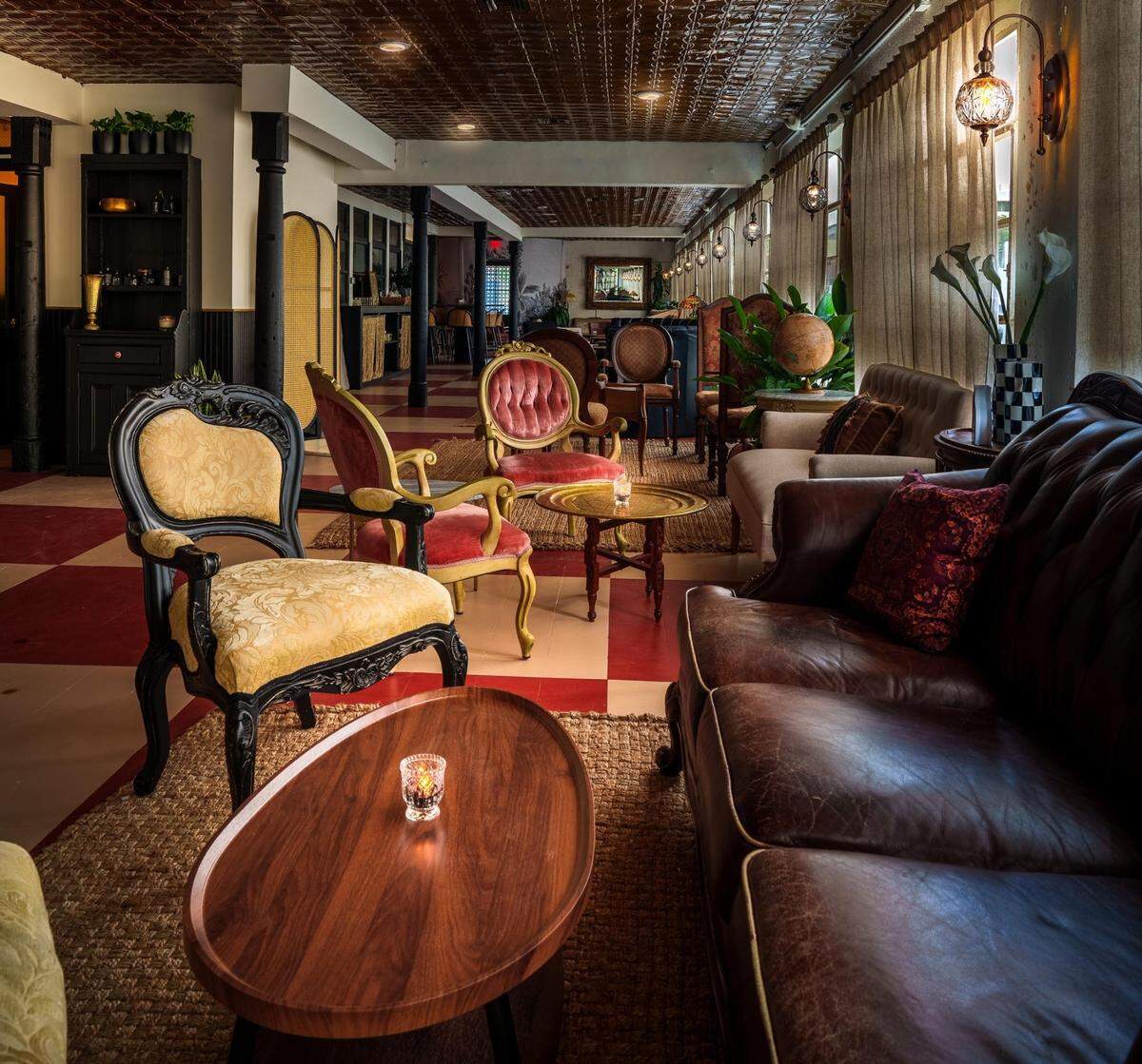 Ornate chairs and comfortable couches add to the atmosphere at Magie, a new wine bar in Miami.