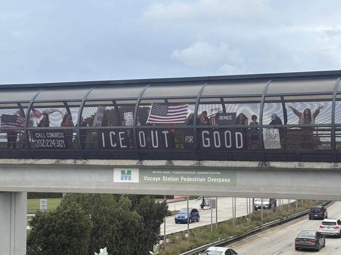 Protesters stand on the Vizcaya pedestrian bridge across U.S 1 in Miami Monday, Jan. 12, 2026, to demonstrate against U.S. Immigration and Customs Enforcement and the Trump administration.