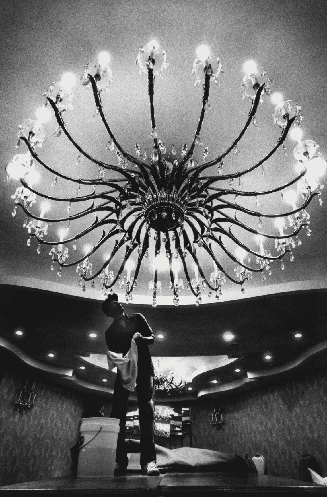 In 1987, Gilbert Samuda, of Crystal Maintenance, cleans a chandelier in the Louis Phillipe room of the Fontainebleau Hotel in Miami Beach. The yearly cleaning takes seven nights.