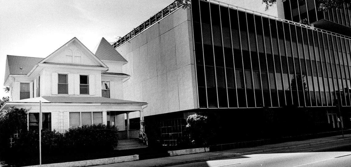 An old home at 624 Brickell Ave. gets squeezed by new buildings.