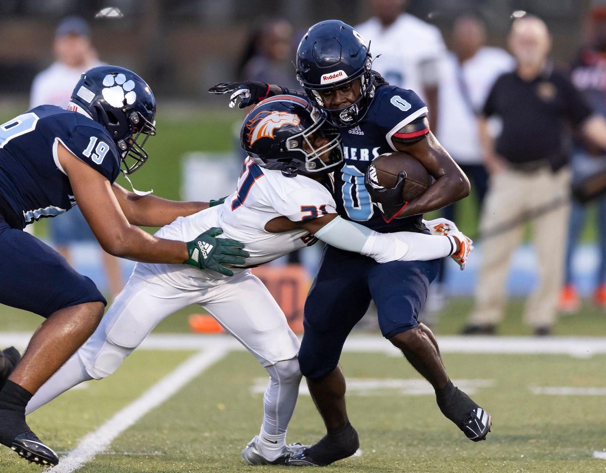 Palmetto Panthers wide receiver Cameron Sapp (0) is tackled by Homestead Broncos defensive back Wilson Smith (21) in the first half of their football game at Tropical Park on Friday, Aug. 23, 2024, in Miami, Fla.