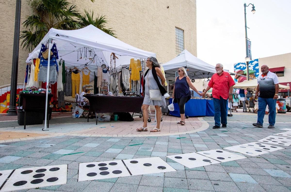 People stroll by Domino Park and an assortment of vendors during Viernes Culturales or Cultural Fridays on Calle Ocho in the Little Havana neighborhood of Miami, Florida, on Friday, May 21, 2021. Viernes Culturales/Cultural Fridays are held on the 3rd Friday of every month in the heart of Little Havana, on Calle Ocho between 13th and 17th Avenues, from 7-11 pm.