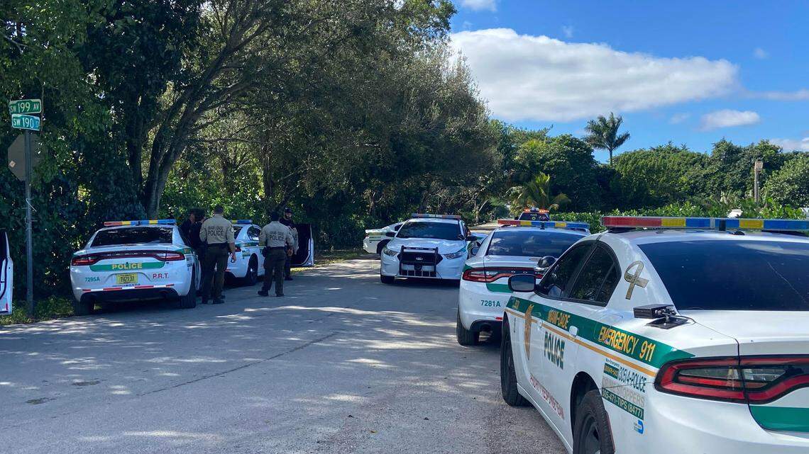 Miami-Dade police gather in front of a house on Southwest 199th Avenue and 190th Street in the Redland agricultural area of the county Monday, Nov. 27, 2023, where they were engaged in a standoff with a barricaded man inside the house.