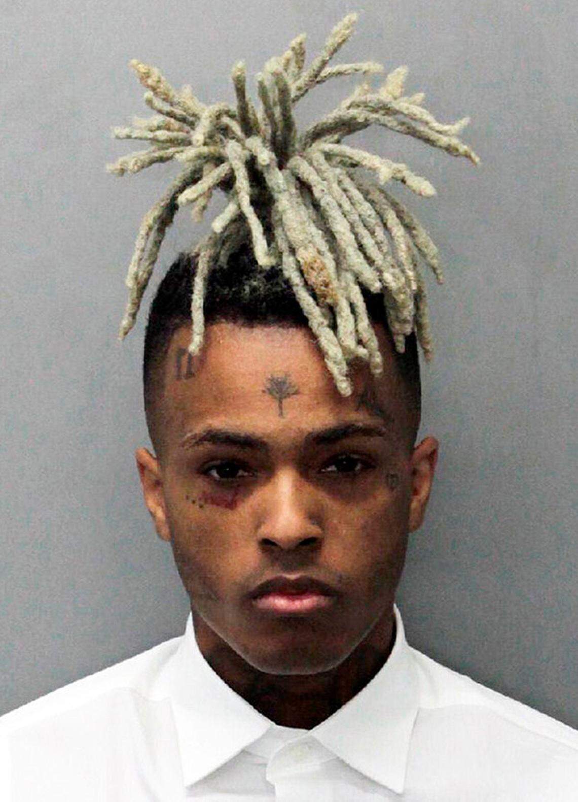 This undated mugshot released by the Miami- Dade Corrections & Rehabilitation Department shows rapper XXXTentacion. Following his death on June 18, 2018, XXXTentacion has topped the Billboard Hot 100 chart with “Sad!” and his two albums have landed in the Top 10. (Miami- Dade Corrections & Rehabilitation Department via AP)
