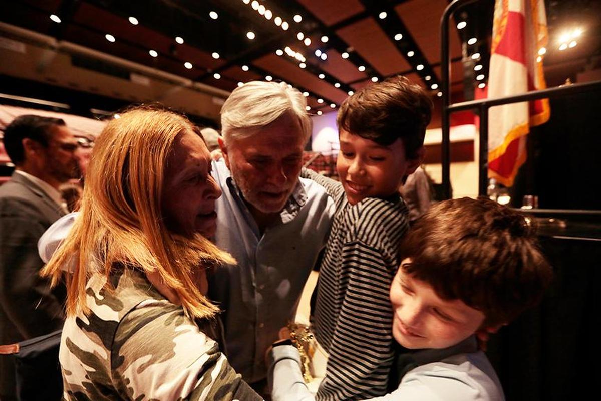 Juan Cristóbal Rondeau, 13, a Westminster Christian seventh grader, gets hugs Thursday from his grandparents Hebe and Carlos Clerc and little brother Nicolas Rondeau, 9, after winning the Miami Herald Spelling Bee for Miami-Dade and Monroe students. He will compete in the nationals in late May and early June.