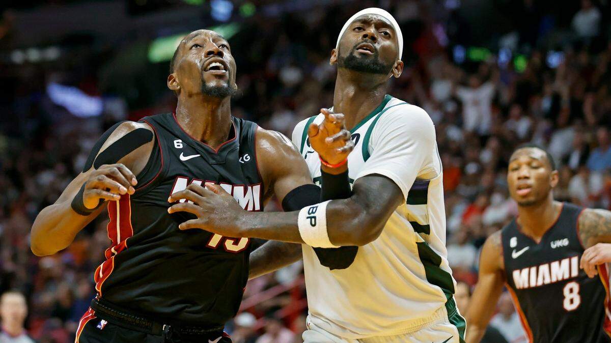 Miami Heat center Bam Adebayo (13) battles Milwaukee Bucks forward Bobby Portis (9) for a rebound in the fourth quarter at the Miami-Dade Arena, in Miami on Thursday, January 12, 2023.