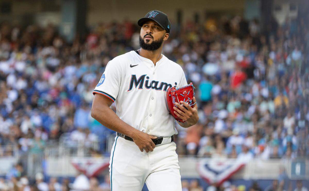 Miami Marlins pitcher Sandy Alcantara (22) leaves the mound after being relived by manager Clayton McCullough (86) in the fifth inning of their Opening Day MLB game against the Pittsburgh Pirates at loanDepot park on Thursday, March 27, 2025, in Miami, Fla.