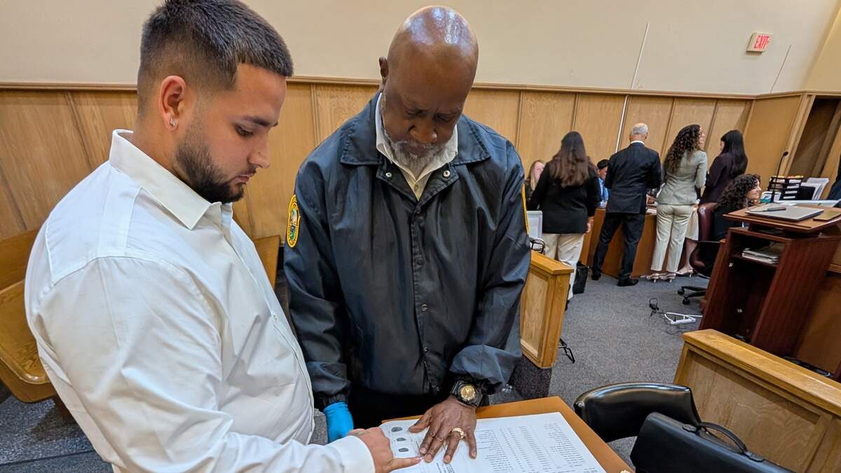 Adolfo Denis Jr., a 25-year-old Homestead resident, is fingerprinted by bailiff Jimmy Harrell in Circuit Judge Tanya Brinkley’s courtroom in Miami. Denis accepted a plea deal on Tuesday, June 23, 2026, for 10 years of probation in a case in which he was accused of injuring a Pinecrest police officer. Denis pleaded guilty to a felony charge of aggravated battery on a law enforcement officer.