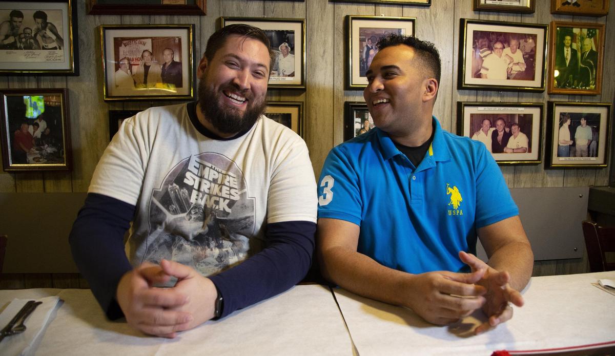 Kevin Garfinkle, left, and Shiva Mahabir share a light moment near the Fort Lauderdale Airport, where they both work. They received their last paychecks on Dec. 29, 2018 — due to the partial government shutdown affecting 800,000 federal workers.