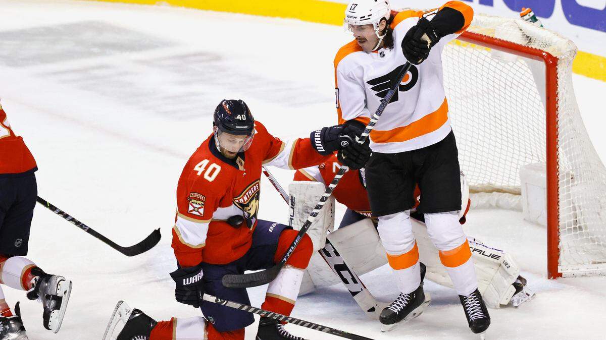 Florida Panthers defenseman Petteri Lindbohm (40) stop a puck as teammate goaltender Sergei Bobrovsky (72) defends the goal from Philadelphia Flyers center Zack MacEwen (17) during the first period of an NHL game at the FLA Live Arena on Thursday, March 10, 2022 in Sunrise, Fl.