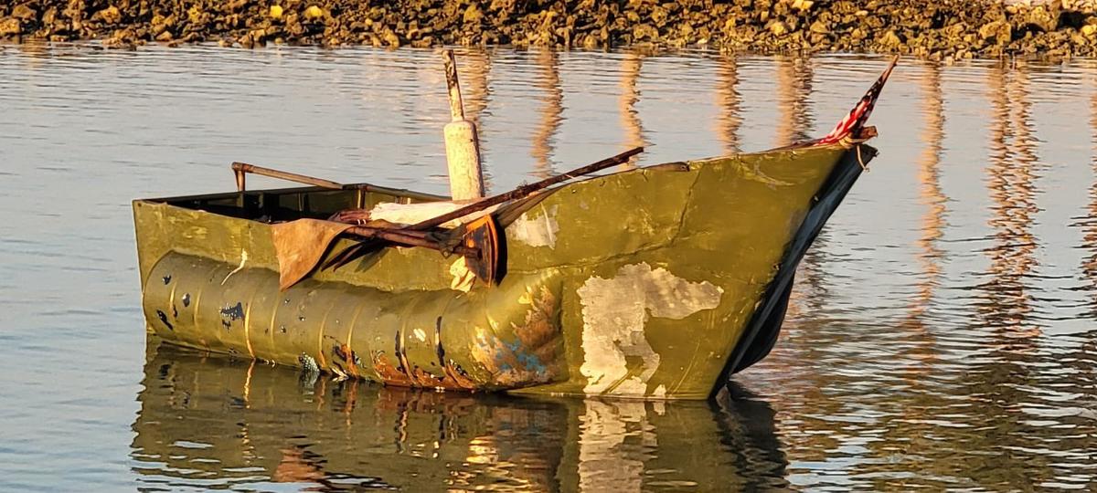 A rustic, homemade migrant vessel floats just offshore of the Florida Keys Sunday, Dec. 11, 2022.
