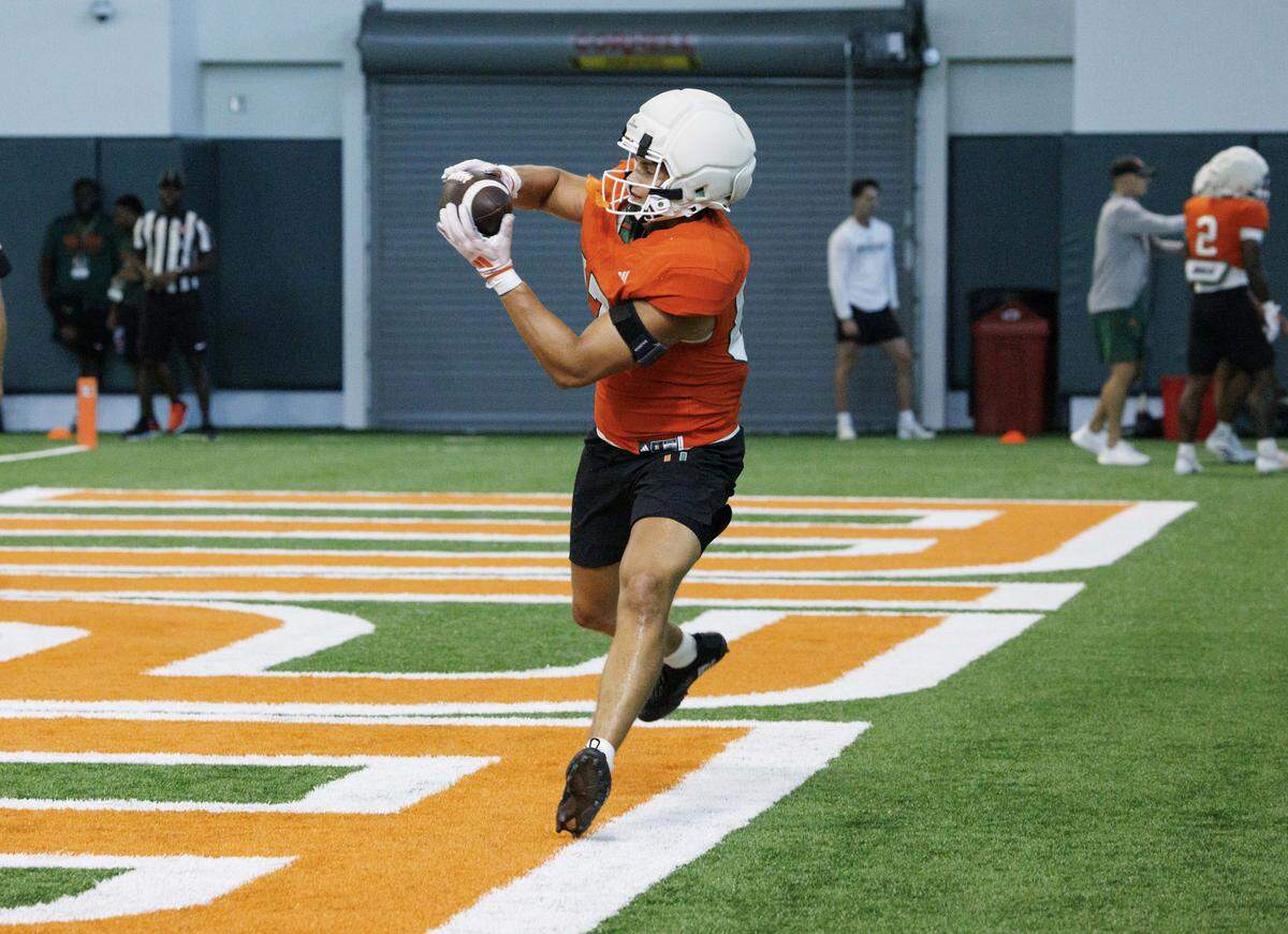 Tight end Alex Bauman (87) catches the ball during Miami Hurricanes football practice on Wednesday, Aug. 6, 2025, at University of Miami in Coral Gables, Fla.