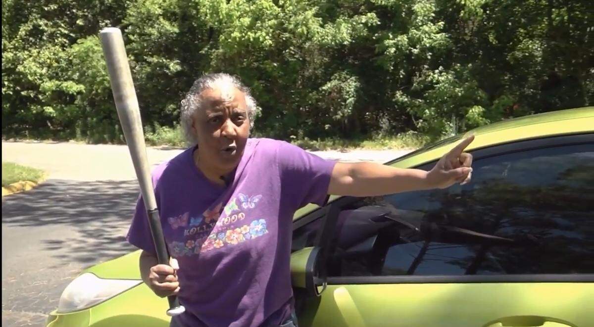 Clarese Gainey, 65, shows WGFL CBS 4 reporters how she used a baseball bat to fend off accused burglar Antonio Mosely on April 14, 2019, in this screengrab.